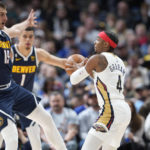 
              New Orleans Pelicans guard Devonte' Graham, right, looks to pass the ball as Denver Nuggets center Nikola Jokic defends in the first half of an NBA basketball game Tuesday, Jan. 31, 2023, in Denver. (AP Photo/David Zalubowski)
            