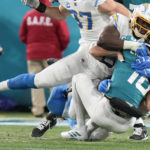 
              Los Angeles Chargers defensive tackle Sebastian Joseph-Day (69) sacks Jacksonville Jaguars quarterback Trevor Lawrence (16) during the first of an NFL wild-card football game, Saturday, Jan. 14, 2023, in Jacksonville, Fla. (AP Photo/Chris O'Meara)
            