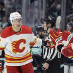 
              Calgary Flames defenseman Nikita Zadorov (16) is congratulated after scoring against the Seattle Kraken during the first period of an NHL hockey game, Friday, Jan. 27, 2023, in Seattle. (AP Photo/John Froschauer)
            