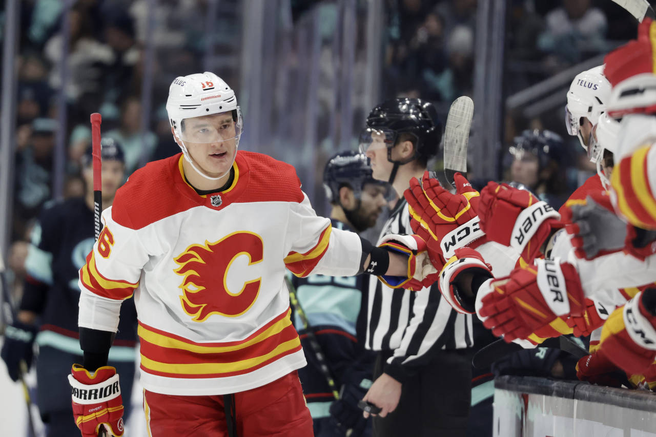 Calgary Flames defenseman Nikita Zadorov (16) is congratulated after scoring against the Seattle Kr...