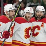 
              From left, Calgary Flames left wing Milan Lucic, Calgary Flames center Jonathan Huberdeau and Calgary Flames defenseman Chris Tanev celebrate Huberdeau's goal during the second period of an NHL hockey game against the Chicago Blackhawks, Sunday, Jan. 8, 2023, in Chicago. (AP Photo/Erin Hooley)
            