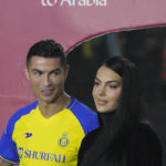 
              Cristiano Ronaldo looks at Georgina Rodriguez as they attend the official unveiling as a new member of Al Nassr soccer club in in Riyadh, Saudi Arabia, Tuesday, Jan. 3, 2023. Ronaldo, who has won five Ballon d'Ors awards for the best soccer player in the world and five Champions League titles, will play outside of Europe for the first time in his storied career. (AP Photo/Amr Nabil)
            