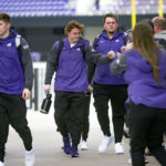 
              TCU quarterback Max Duggan fist bumps support staff as he leaves with his team for the NCAA College Football Playoff championship game against Georgia, outside Amon G. Carter Stadium in Fort Worth, Texas, Friday, Jan. 6, 2023. (Madeleine Cook/Star-Telegram via AP)
            