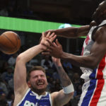 
              Dallas Mavericks guard Luka Doncic, left, is fouled by Detroit Pistons center Isaiah Stewart, right, in the second half of an NBA basketball game Monday, Jan. 30, 2023, in Dallas. (AP Photo/Richard W. Rodriguez)
            