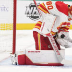 
              Calgary Flames goaltender Dan Vladar defects a shot during the first period of an NHL hockey game against the Dallas Stars in Dallas, Saturday, Jan. 14, 2023. (AP Photo/LM Otero)
            