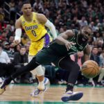 
              Boston Celtics' Jaylen Brown (7) looses control of the ball in front of Los Angeles Lakers' Russell Westbrook (0) during the first half of an NBA basketball game, Saturday, Jan. 28, 2023, in Boston. (AP Photo/Michael Dwyer)
            