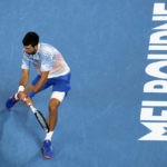 
              Novak Djokovic of Serbia plays a backhand return to Andrey Rublev of Russia during their quarterfinal match at the Australian Open tennis championship in Melbourne, Australia, Wednesday, Jan. 25, 2023. (AP Photo/Aaron Favila)
            