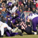 
              Minnesota Vikings running back Dalvin Cook (4) tries to break a tackle by Chicago Bears linebacker Joe Thomas (45) during the first half of an NFL football game, Sunday, Jan. 8, 2023, in Chicago. (AP Photo/Nam Y. Huh)
            