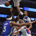 
              Detroit Pistons forward Saddiq Bey, center, shoots against Dallas Mavericks center JaVale McGee, right, and guard Jaden Hardy (3) in the first half of an NBA basketball game Monday, Jan. 30, 2023, in Dallas. (AP Photo/Richard W. Rodriguez)
            