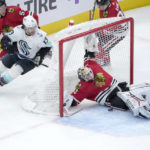 
              Chicago Blackhawks goaltender Alex Stalock, right, makes a save as Seattle Kraken's Brandon Tanev (13) looks for a rebound during the second period of an NHL hockey game Saturday, Jan. 14, 2023, in Chicago. (AP Photo/Charles Rex Arbogast)
            