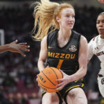 
              Missouri guard Luraen Hansen, left, drives to the hoop against South Carolina guard Zia Cooke, right, during the first half of an NCAA college basketball game, Sunday, Jan. 15, 2023, in Columbia, S.C. (AP Photo/Sean Rayford)
            