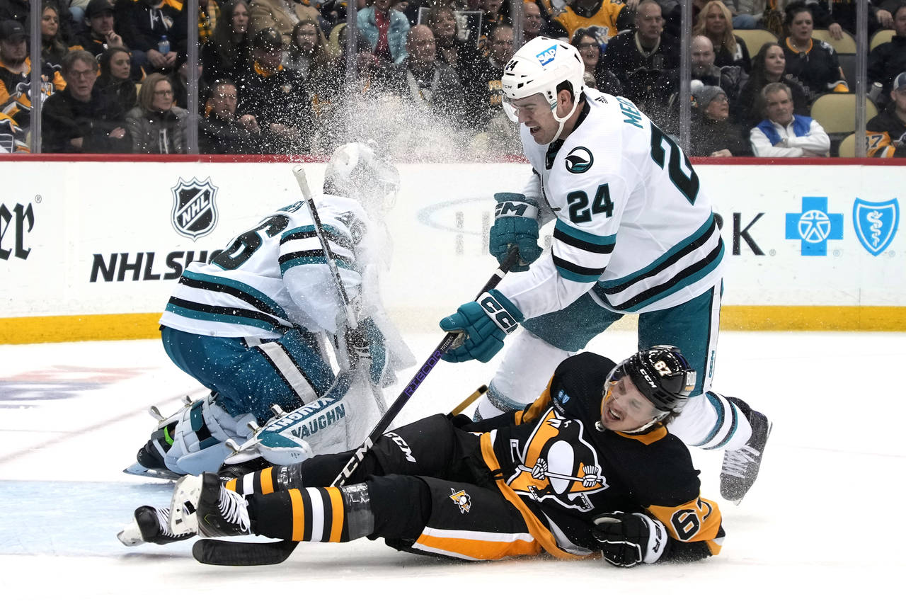 Pittsburgh Penguins' Rickard Rakell (67) is upended by San Jose Sharks' Jaycob Megna (24) during th...