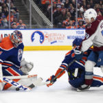 
              Colorado Avalanche center Ben Meyers (59) is stopped by Edmonton Oilers goalie Stuart Skinner (74) as Darnell Nurse (25) defends during the third period of an NHL hockey game Saturday, Jan. 7, 2023, in Edmonton, Alberta. (Jason Franson/The Canadian Press via AP)
            