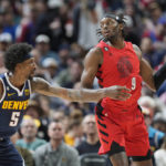 
              Portland Trail Blazers forward Jerami Grant, right, looks to pass the ball as Denver Nuggets guard Kentavious Caldwell-Pope defends during the second half of an NBA basketball game Tuesday, Jan. 17, 2023, in Denver. (AP Photo/David Zalubowski)
            