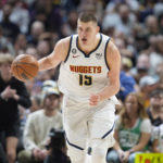 
              Denver Nuggets center Nikola Jokic collects a loose ball in the second half of an NBA basketball game against the Boston Celtics, Sunday, Jan. 1, 2023, in Denver. (AP Photo/David Zalubowski)
            