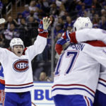 
              Montreal Canadiens right wing Cole Caufield, left, reacts after scoring a goal against the New York Rangers in the third period of an NHL hockey game Sunday, Jan. 15, 2023, in New York. (AP Photo/Adam Hunger)
            
