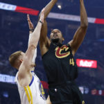 
              Cleveland Cavaliers forward Evan Mobley (4) shoots against Golden State Warriors guard Donte DiVincenzo during the first half of an NBA basketball game Friday, Jan. 20, 2023, in Cleveland. (AP Photo/Ron Schwane)
            
