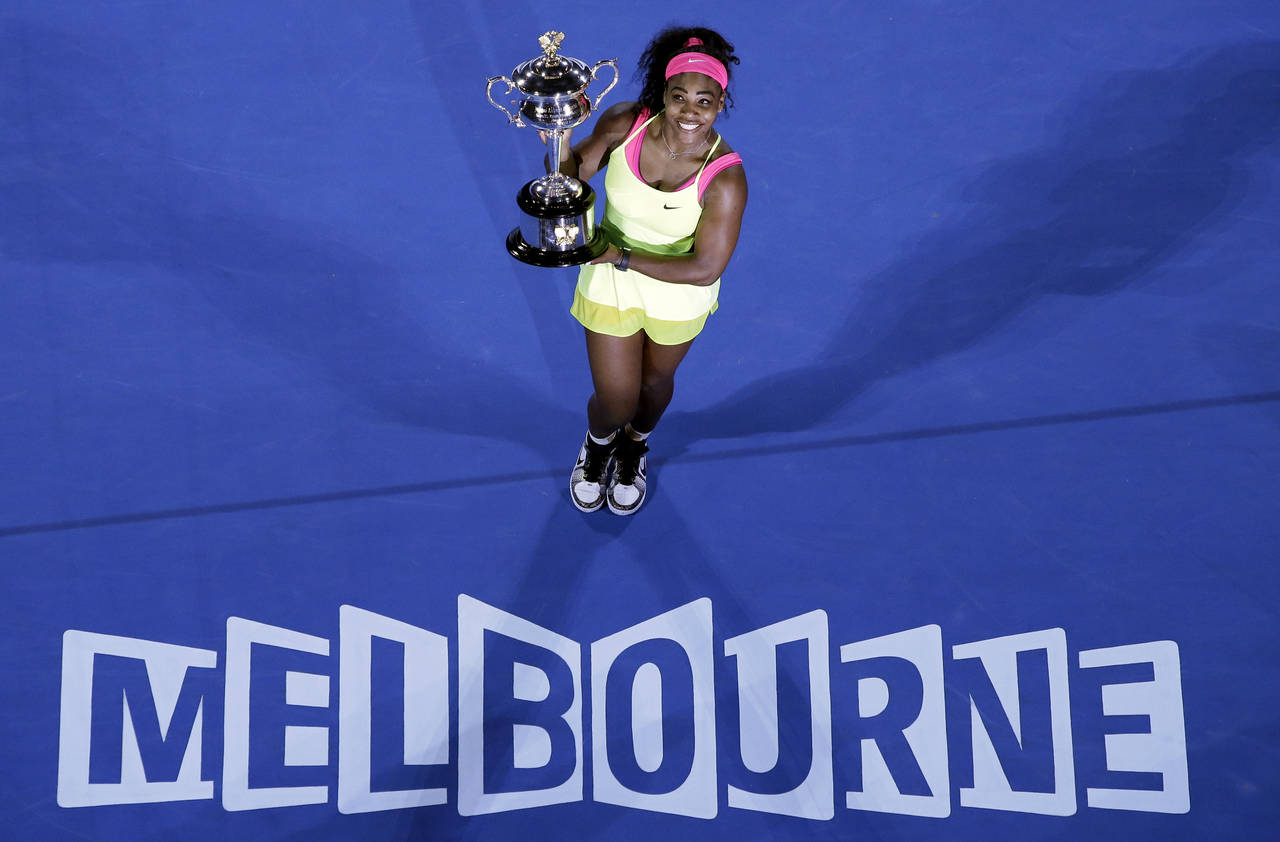 FILE - Serena Williams holds the trophy after defeating Maria Sharapova in the women's singles fina...