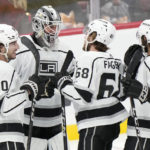 
              Los Angeles Kings goaltender Pheonix Copley, second from left, is congratulated by teammates after the Kings beat the Florida Panthers 4-3 during an NHL hockey game, Friday, Jan. 27, 2023, in Sunrise, Fla. From left: Sean Durzi, Copley, Samuel Fagemo and Alex Iafallo. (AP Photo/Wilfredo Lee)
            