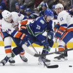 
              New York Islanders' Jean-Gabriel Pageau (44) checks Vancouver Canucks' Lane Pederson (29) during the third period of an NHL hockey game Tuesday, Jan. 3, 2023, in Vancouver, British Columbia. (Darryl Dyck/The Canadian Press via AP)
            