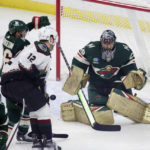 
              Minnesota Wild goaltender Marc-Andre Fleury (29) tracks a shot as Arizona Coyotes left wing Nick Ritchie (12) and Wild defenseman Jared Spurgeon (46) battle for position in the first period during an NHL hockey game Saturday, Jan. 14, 2023, in St. Paul, Minn. (AP Photo/Andy Clayton-King)
            
