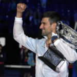 
              Novak Djokovic of Serbia gestures as he holds the Norman Brookes Challenge Cup after defeating Stefanos Tsitsipas of Greece in the men's singles final at the Australian Open tennis championship in Melbourne, Australia, Sunday, Jan. 29, 2023. (AP Photo/Aaron Favila)
            