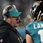
              Jacksonville Jaguars head coach Doug Pederson, left, speaks to Jacksonville Jaguars quarterback Trevor Lawrence (16) on the sidelines during the first half of an NFL wild-card football game against the Los Angeles Chargers, Saturday, Jan. 14, 2023, in Jacksonville, Fla. (AP Photo/Chris O'Meara)
            