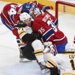 
              Boston Bruins' Taylor Hall (71) slides in on Montreal Canadiens goaltender Sam Montembeault as Canadiens' Jordan Harris (54) defends during the first period of an NHL hockey game in Montreal, Tuesday, Jan. 24, 2023. (Graham Hughes/The Canadian Press via AP)
            