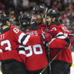 
              New Jersey Devils' Dougie Hamilton, center, celebrates with Jesper Bratt, Jack Hughes and Nico Hischier after scoring the game-winning goal during the overtime period of an NHL hockey game, Sunday, Jan. 22, 2023, in Newark, N.J. The Devils won 2-1 in overtime. (AP Photo/Frank Franklin II)
            