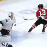 
              Seattle Kraken goaltender Martin Jones makes a save on a shot by Chicago Blackhawks' Max Domi during the first period of an NHL hockey game Saturday, Jan. 14, 2023, in Chicago. (AP Photo/Charles Rex Arbogast)
            