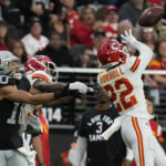 
              Kansas City Chiefs safety Juan Thornhill (22) intercepts a pass intended for Las Vegas Raiders wide receiver Mack Hollins (10) during the first half of an NFL football game Saturday, Jan. 7, 2023, in Las Vegas. (AP Photo/John Locher)
            