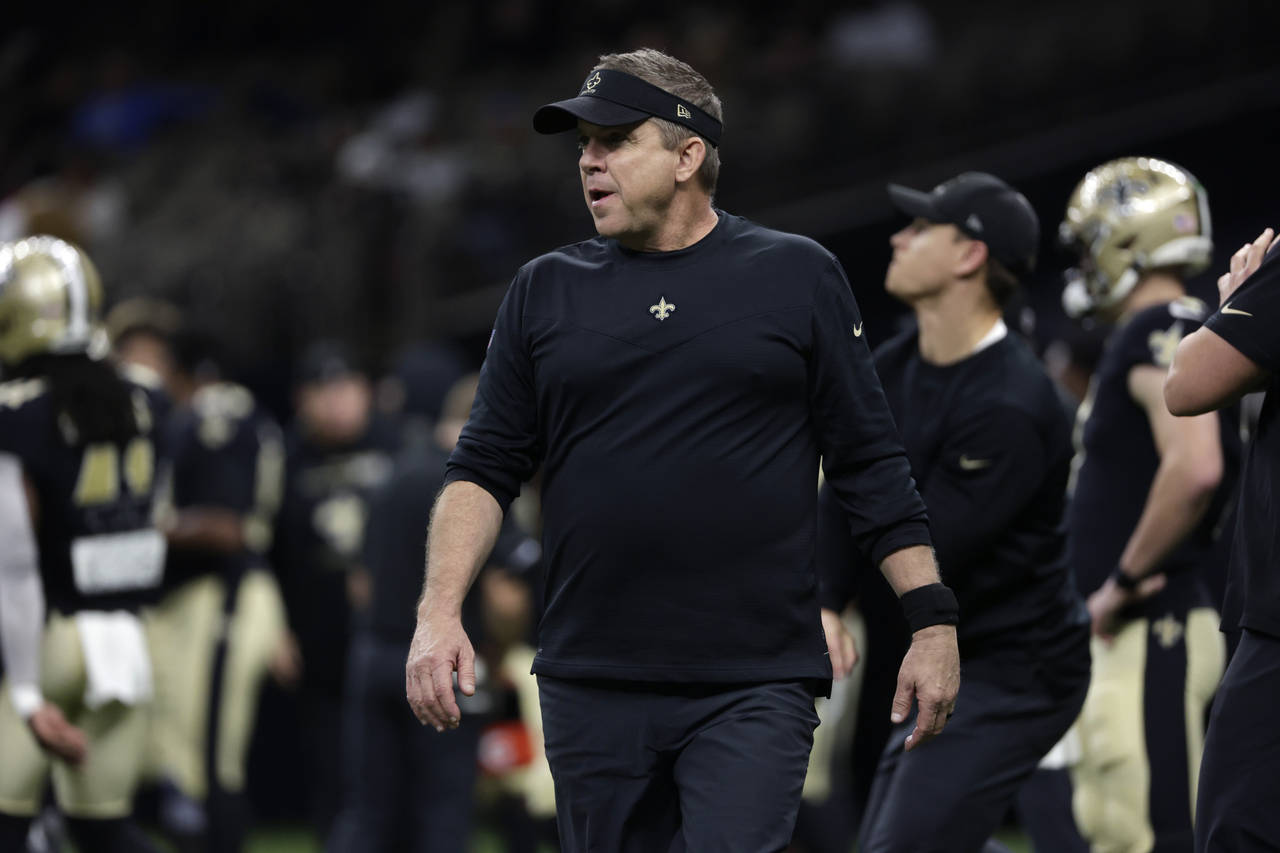 FILE - New Orleans Saints head coach Sean Payton walks on the field before an NFL football game aga...