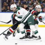 
              Buffalo Sabres right wing Kyle Okposo (21) is checked by Minnesota Wild defenseman Jake Middleton (5) during the first period of an NHL hockey game, Saturday, Jan. 7, 2023, in Buffalo, N.Y. (AP Photo/Jeffrey T. Barnes)
            