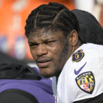 
              FILE - Baltimore Ravens quarterback Lamar Jackson (8) watches from the sideline during the first half of an NFL football game against the Jacksonville Jaguars, Sunday, Nov. 27, 2022, in Jacksonville, Fla. Lamar Jackson was again absent from practice during the portion open to reporters Wednesday, Jan. 11, 2023. The Baltimore star hasn't practiced since injuring his knee in a Dec. 4 win over Denver, and there was no sign of him Wednesday as the Ravens prepared for Sunday night's playoff opener at Cincinnati. Jackson missed the final five games of the regular season. (AP Photo/Phelan M. Ebenhack, File)
            