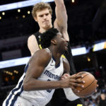 
              Memphis Grizzlies forward Jaren Jackson Jr. (13) handles the ball against Utah Jazz forward Lauri Markkanen in the second half of an NBA basketball game, Sunday, Jan. 8, 2023, in Memphis, Tenn. (AP Photo/Brandon Dill)
            