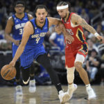 
              Orlando Magic guard Jalen Suggs (4) pushes the ball up the court as New Orleans Pelicans guard Jose Alvarado, right, defends during the first half of an NBA basketball game Friday, Jan. 20, 2023, in Orlando, Fla. (AP Photo/Phelan M. Ebenhack)
            