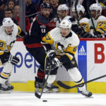 
              Pittsburgh Penguins' Sidney Crosby (87) controls the puck after taking it away from Carolina Hurricanes' Calvin de Haan (44) with teammate Jake Guentzel (59) nearby during the first period of an NHL hockey game in Raleigh, N.C., Saturday, Jan. 14, 2023. (AP Photo/Karl B DeBlaker)
            