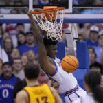 
              Kansas forward K.J. Adams Jr. (24) dunks the ball during the second half of an NCAA college basketball game against Iowa State Saturday, Jan. 14, 2023, in Lawrence, Kan. Kansas won 62-60 (AP Photo/Charlie Riedel)
            