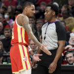 
              Atlanta Hawks guard Dejounte Murray, left, speaks with referee Mitchell Ervin, right, after being called for a foul during the second half of an NBA basketball game against the Portland Trail Blazers in Portland, Ore., Monday, Jan. 30, 2023. The Blazers won 129-125. (AP Photo/Steve Dykes)
            