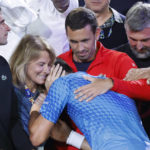 
              Novak Djokovic of Serbia, center, celebrates with his team including his mother, Dijana, second left, after defeating Stefanos Tsitsipas of Greece in the men's singles final at the Australian Open tennis championships in Melbourne, Australia, Sunday, Jan. 29, 2023. (AP Photo/Asanka Brendon Ratnayake)
            