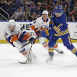 
              Buffalo Sabres center Casey Mittelstadt (37) shoots while defended by New York Islanders defenseman Scott Mayfield (24) during the first period of an NHL hockey game Thursday, Jan. 19, 2023, in Buffalo, N.Y. (AP Photo/Joshua Bessex)
            