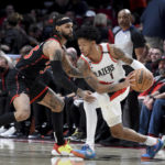 
              Toronto Raptors guard Gary Trent Jr., left, defends against Portland Trail Blazers guard Anfernee Simons during the first half of an NBA basketball game in Portland, Ore., Saturday, Jan. 28, 2023. (AP Photo/Steve Dykes)
            