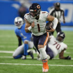 
              Chicago Bears quarterback Justin Fields scrambles during the first half of an NFL football game against the Detroit Lions, Sunday, Jan. 1, 2023, in Detroit. (AP Photo/Paul Sancya)
            