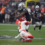 
              Las Vegas Raiders tight end Darren Waller (83) catches a pass over Kansas City Chiefs safety Bryan Cook (6) during the second half of an NFL football game Saturday, Jan. 7, 2023, in Las Vegas. (AP Photo/John Locher)
            
