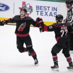 
              Carolina Hurricanes' Martin Necas (88) and Brett Pesce (22) celebrate after Necas scored in overtime of the team's NHL hockey game against the Dallas Stars, Wednesday, Jan. 25, 2023, in Dallas. The Hurricanes won 3-2. (AP Photo/Tony Gutierrez)
            