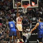 
              Miami Heat forward Haywood Highsmith (24) shoots over Orlando Magic center Bol Bol (10) and center Moritz Wagner (21) during the first half of an NBA basketball game, Friday, Jan. 27, 2023, in Miami. (AP Photo/Lynne Sladky)
            