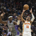 
              Atlanta Hawks guard Trae Young (11) is fouled by Sacramento Kings guard Terence Davis (3) during the first quarter in an NBA basketball game in Sacramento, Calif., Wednesday, Jan. 4, 2023. (AP Photo/José Luis Villegas)
            