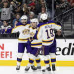 
              Los Angeles Kings center Phillip Danault (24), right wing Viktor Arvidsson (33) and left wing Alex Iafallo (19) celebrate after Arvidsson scored against the Vegas Golden Knights during the third period of an NHL hockey game Saturday, Jan. 7, 2023, in Las Vegas. (AP Photo/Ellen Schmidt)
            