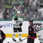 
              Dallas Stars' Wyatt Johnston (53) celebrates with Jamie Benn (14) after scoring during the first period of an NHL hockey game, as Carolina Hurricanes' Paul Stastny (26) and Andrei Svechnikov (37) skate past Wednesday, Jan. 25, 2023, in Dallas. (AP Photo/Tony Gutierrez)
            