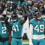 
              Jacksonville Jaguars linebacker Josh Allen (41) and safety Rayshawn Jenkins (2) celebrate their hit that forced a fumble and their return for a touchdown in the second half of an NFL football game against the Tennessee Titans, Saturday, Jan. 7, 2023, in Jacksonville, Fla. (AP Photo/John Raoux)
            